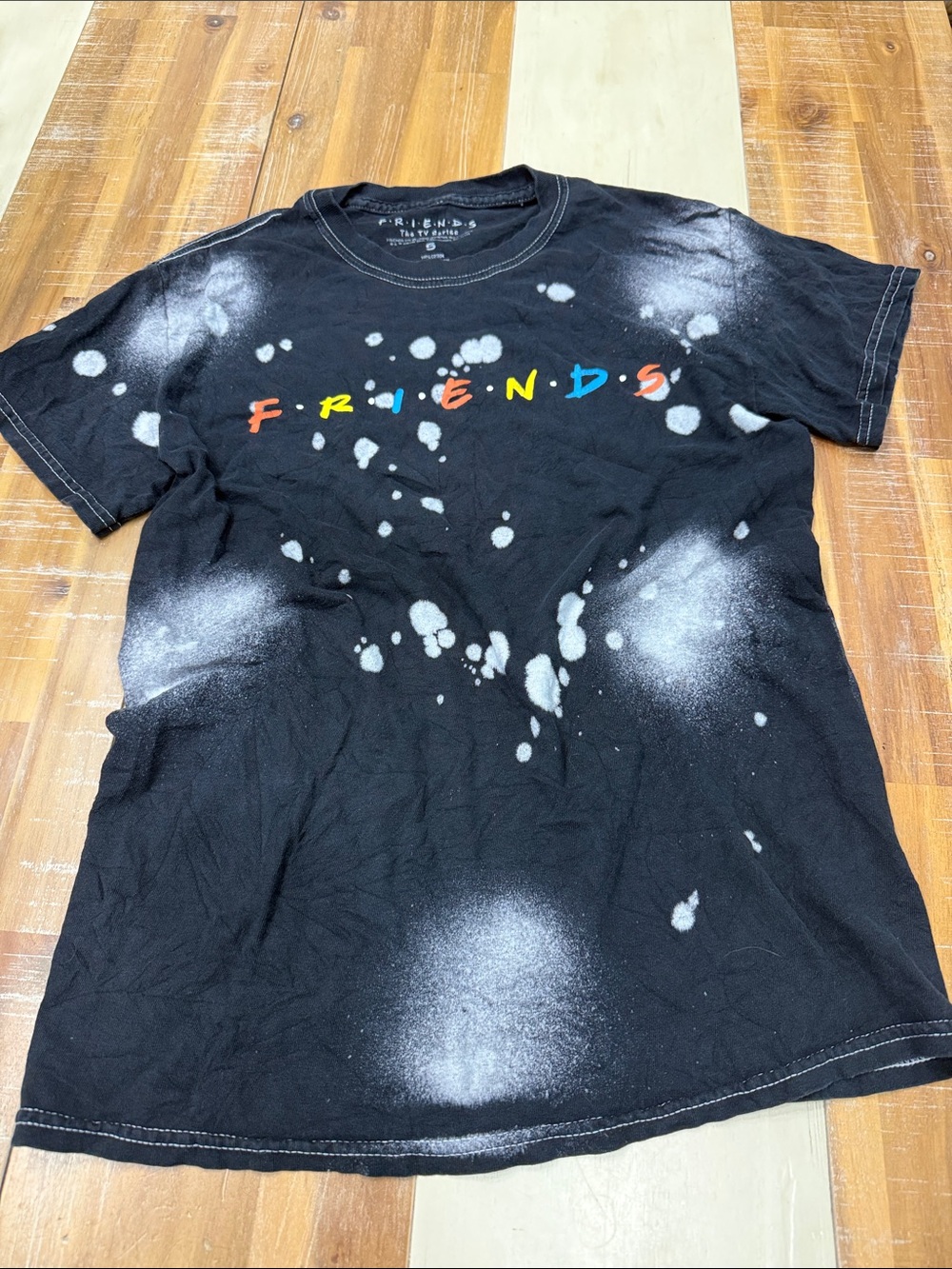 FRIENDS Black Tee with Multicolor Logo and Bleach-Splatter Detail